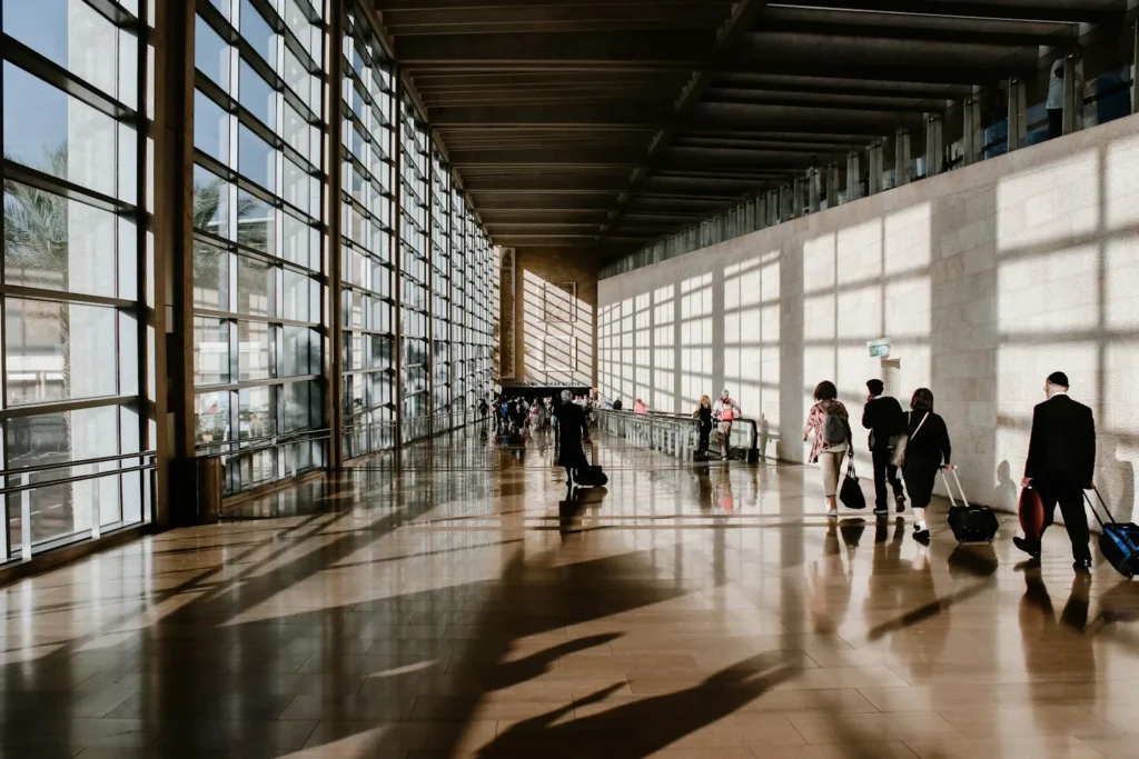 Travellers walking through an airport terminal
