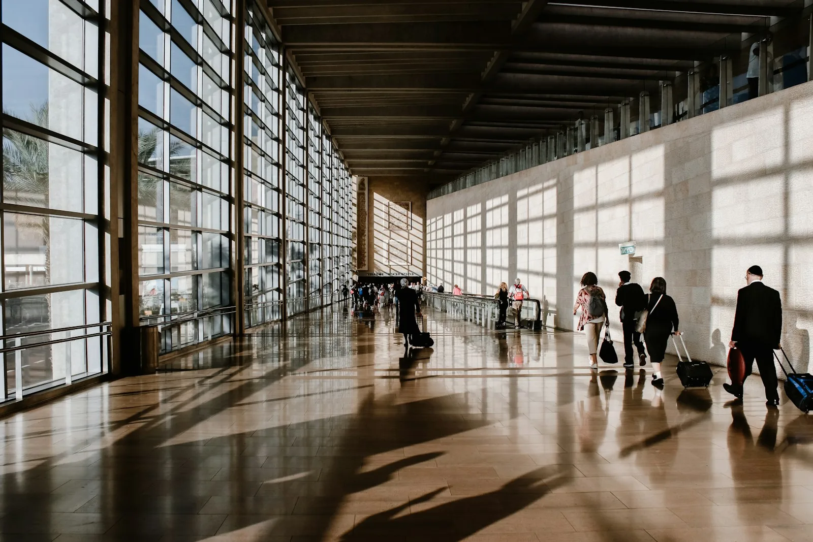 Travellers walking through an airport terminal