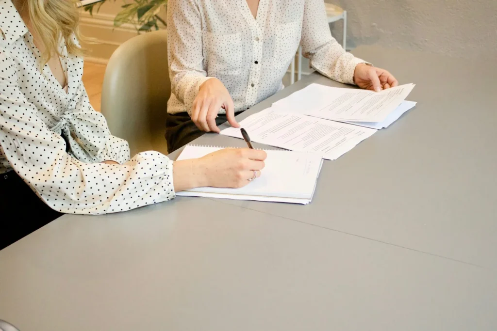 Signing registration documents at a desk