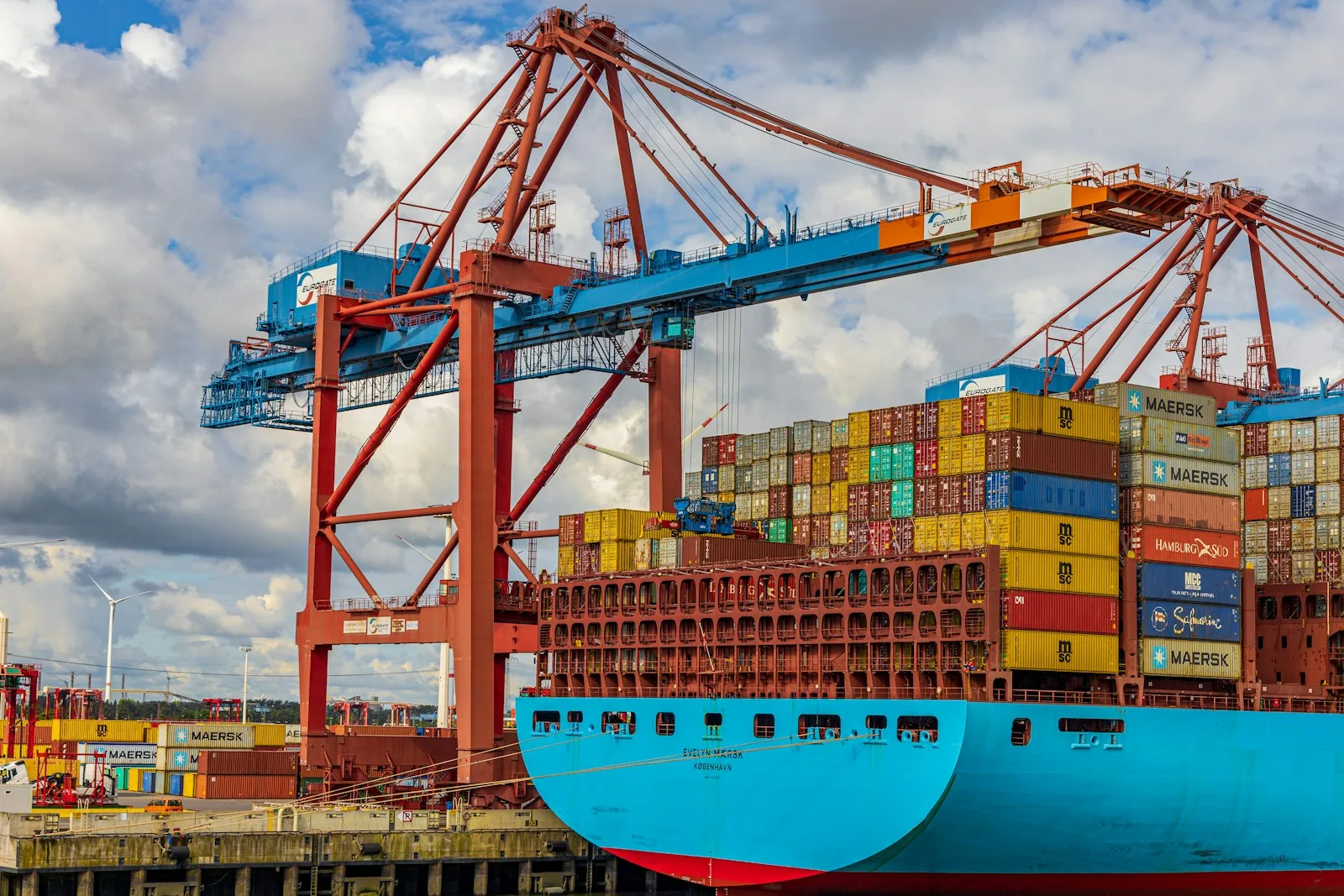 Container ship being loaded by gantry cranes at a port