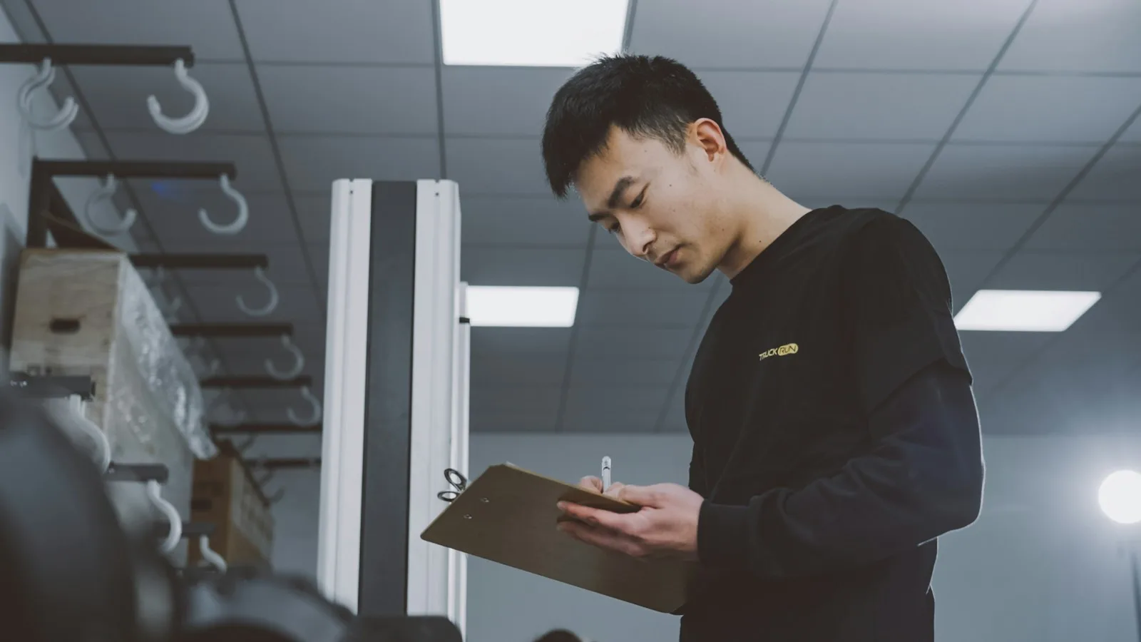 Inspector checking an order list with a clipboard