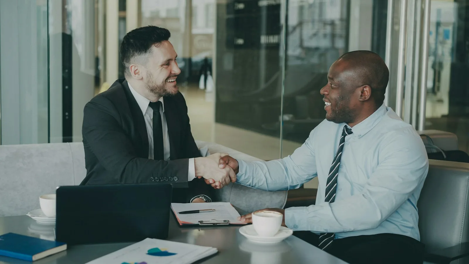 Two business partners shaking hands in an office