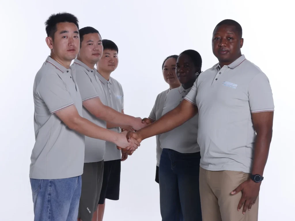 The Shanghai Ssípín team shaking hands in company polos
