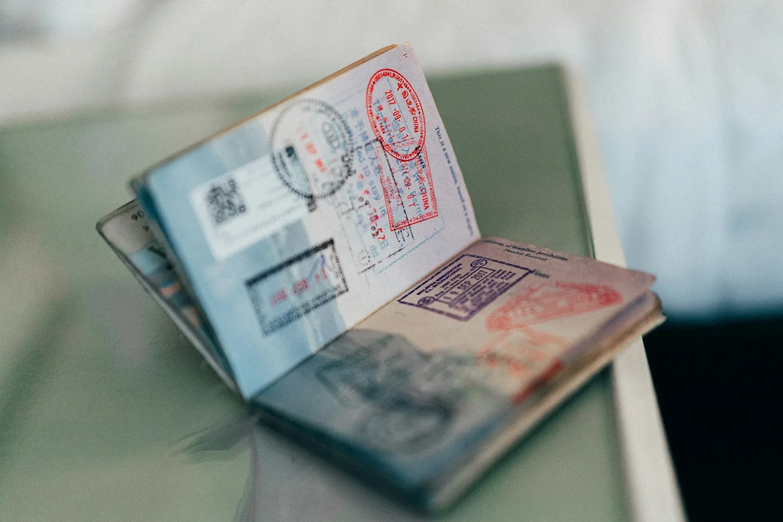 Open passport with visa stamps