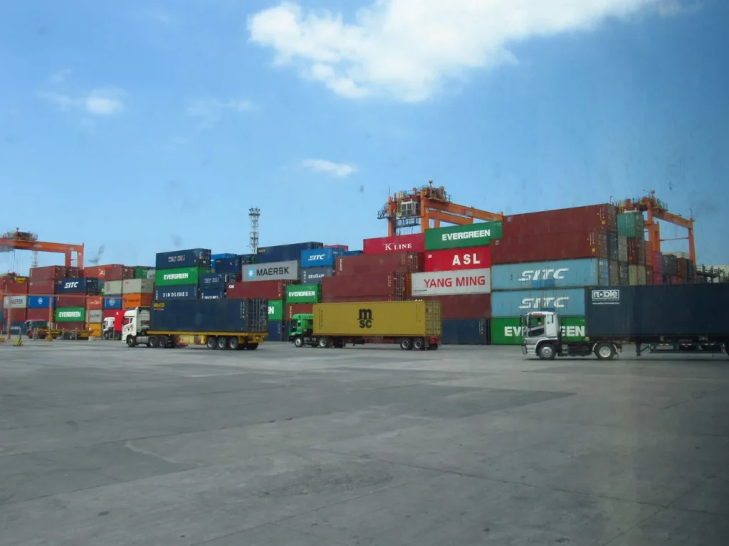 Container port with trucks and cranes